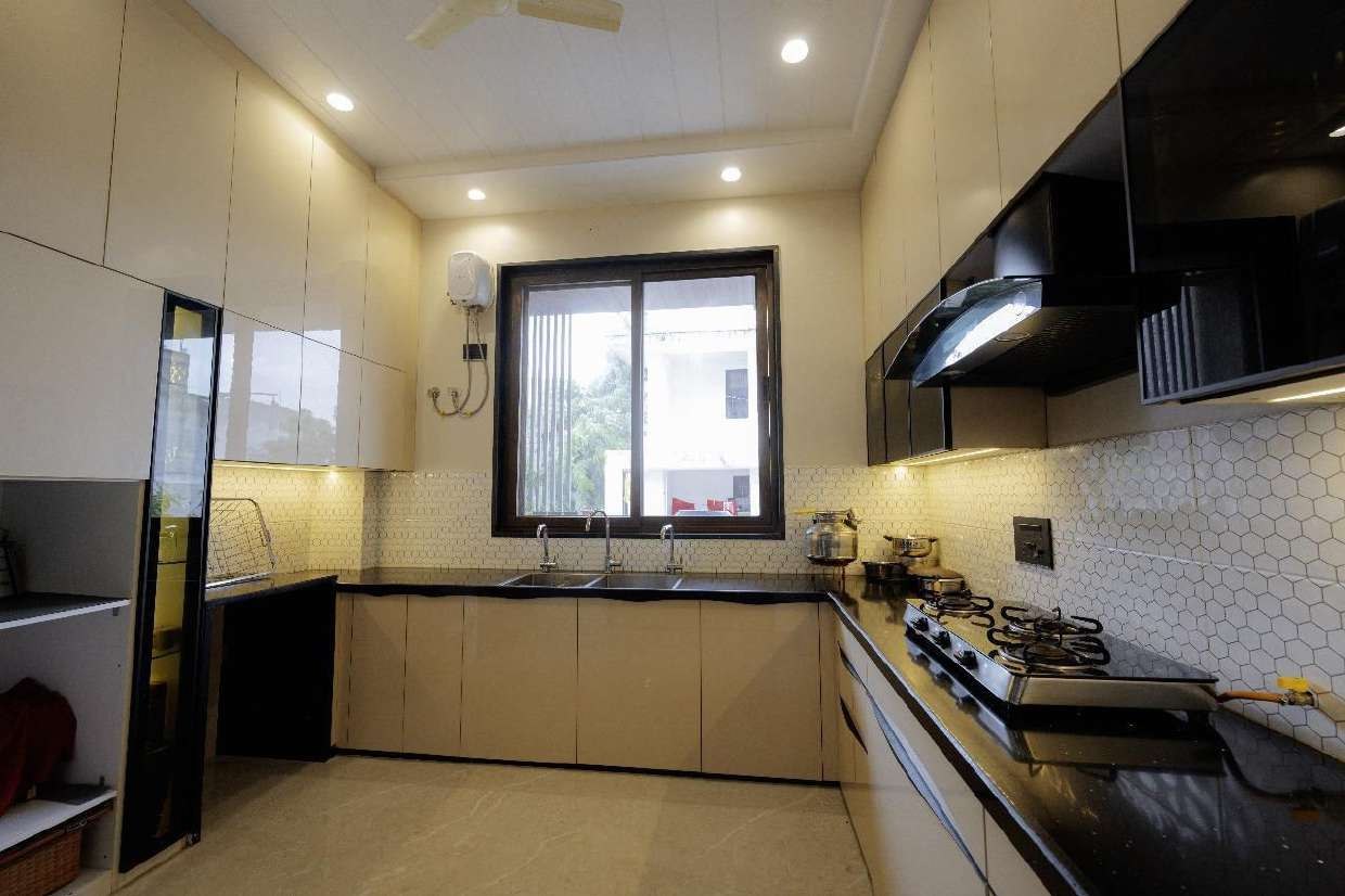 Premium modular kitchen with marble flooring and gold-trim cabinetry
