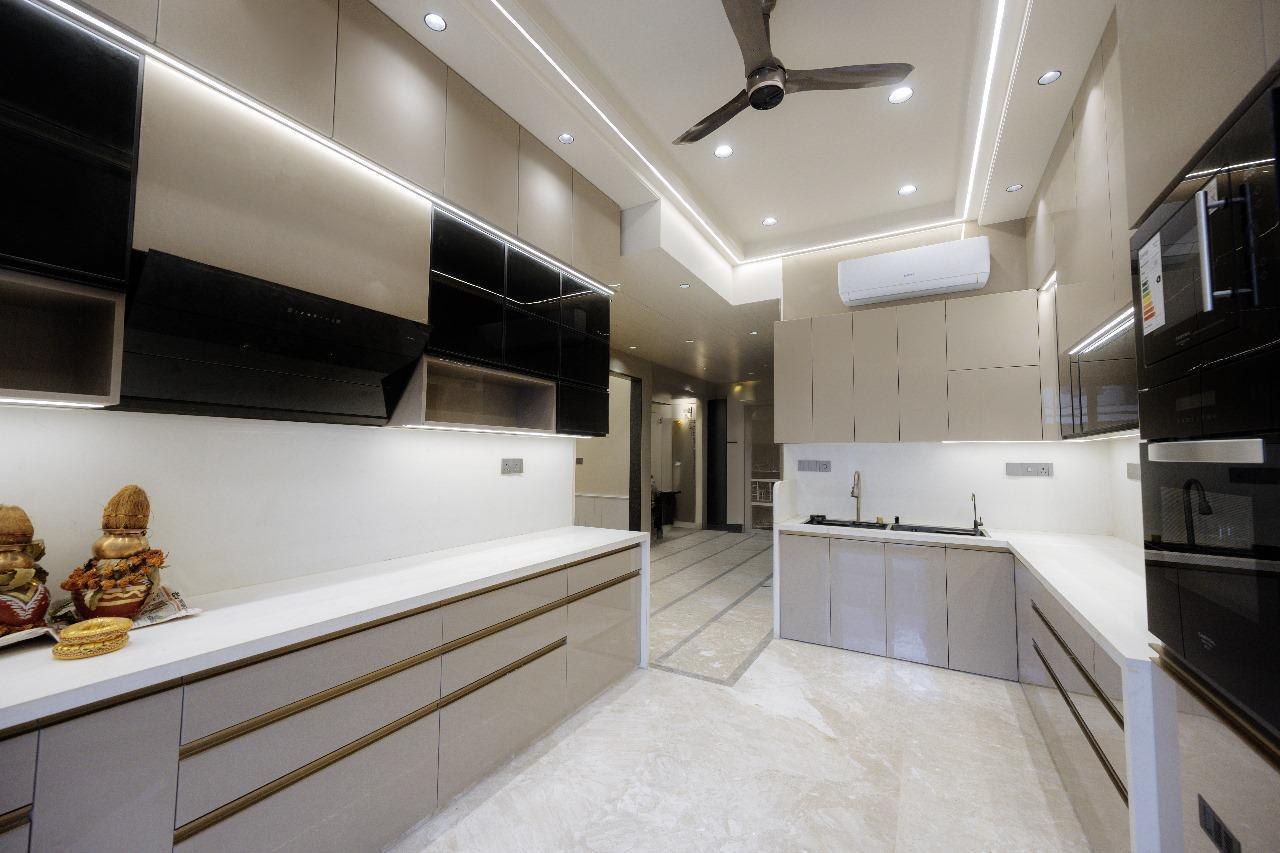 Taupe modular kitchen corridor with gold trim handles