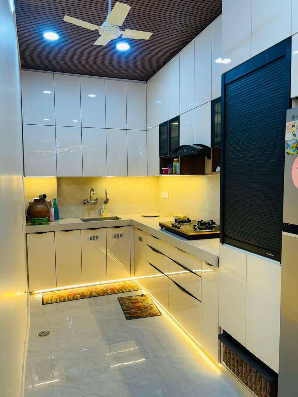 Wide-angle view of white gloss modular kitchen